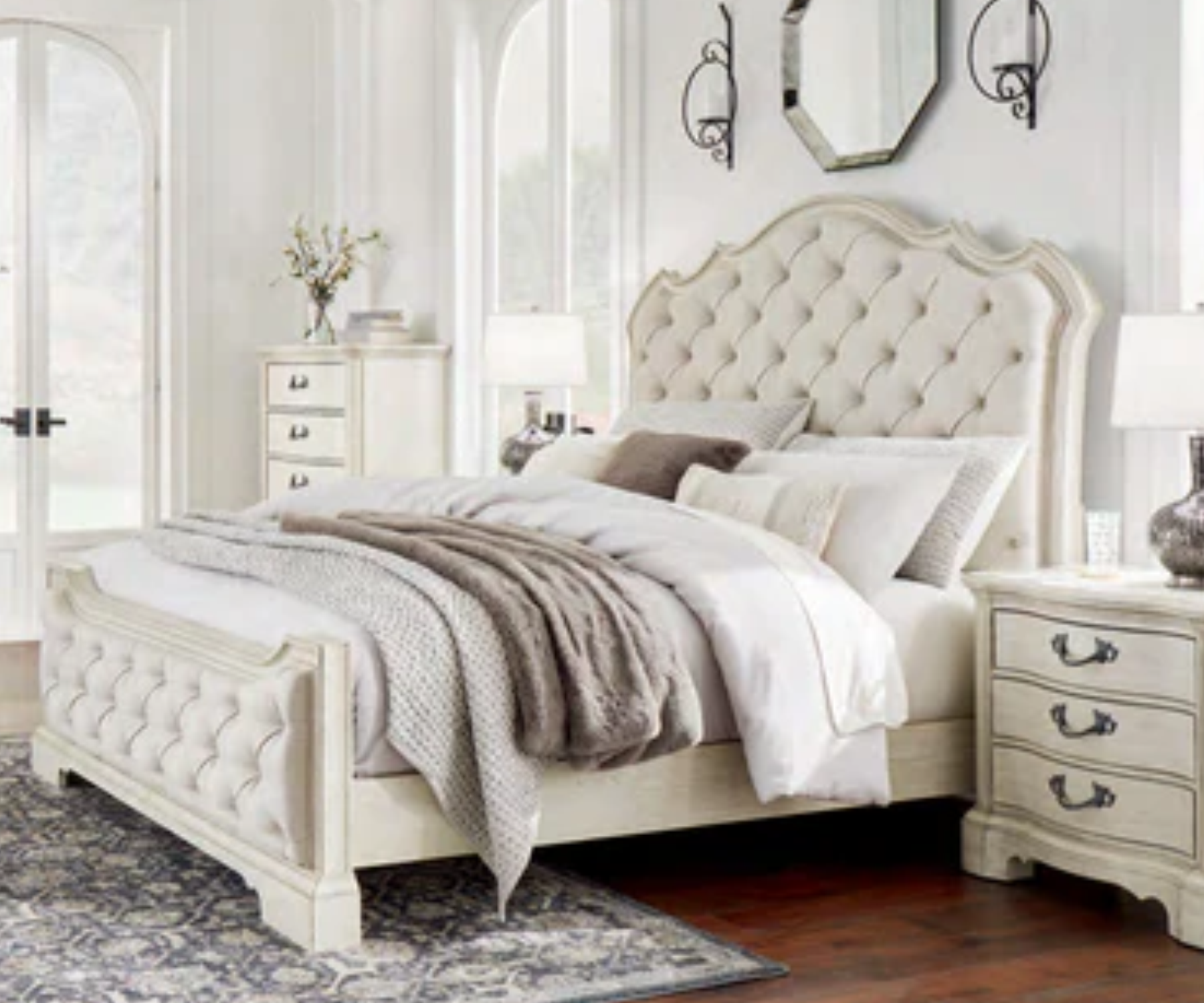 My Furniture classic cream tufted upholstered bed with ornate carved wood frame, matching nightstand with vintage handles, styled in a luxurious traditional bedroom.
